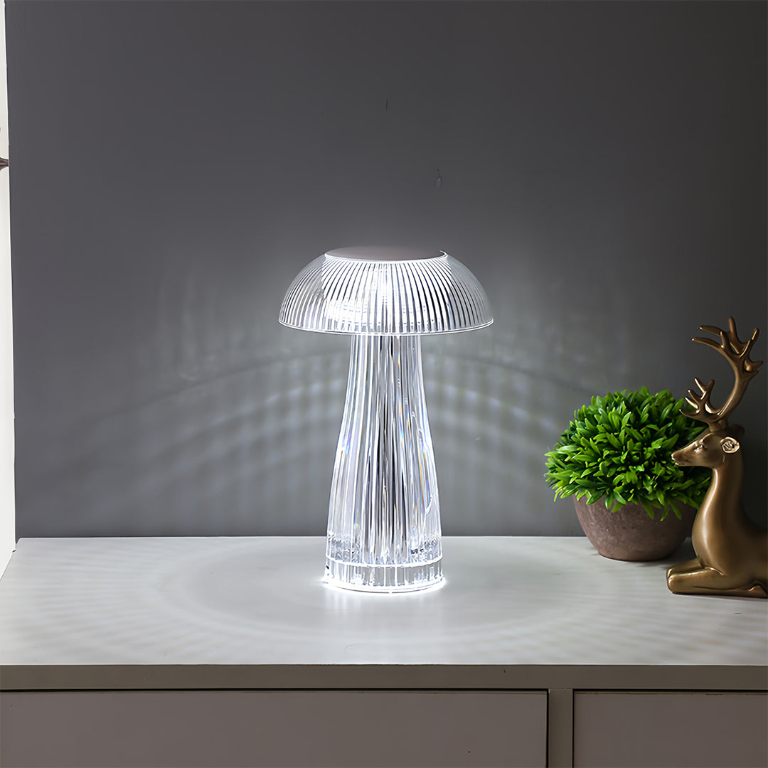 Clear table lamp positioned on white surface creating ambient lighting atmosphere