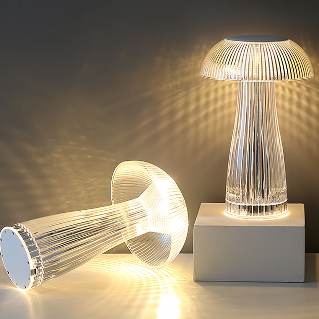 Multiple clear table lamps displaying warm light patterns on contemporary shelf display
