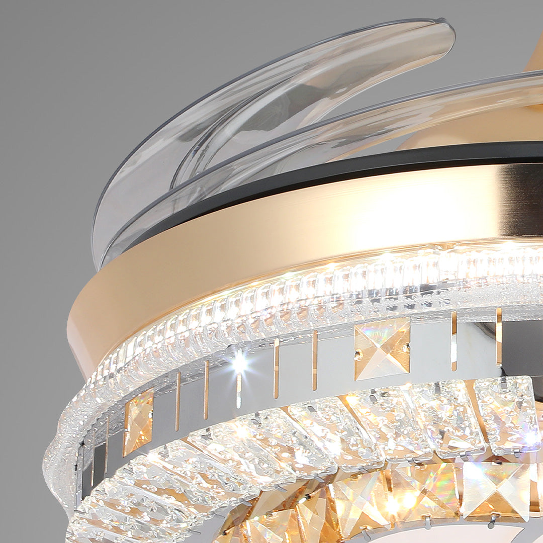 Close-up of amber crystal gold ceiling fan with light and polished mirrored band 