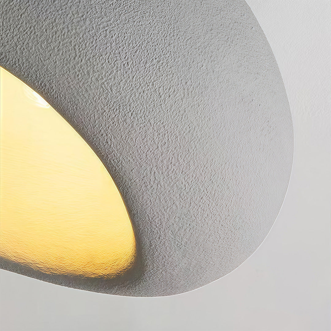 Close-up of art deco flush mount ceiling light, detailed view of warm glow and texture