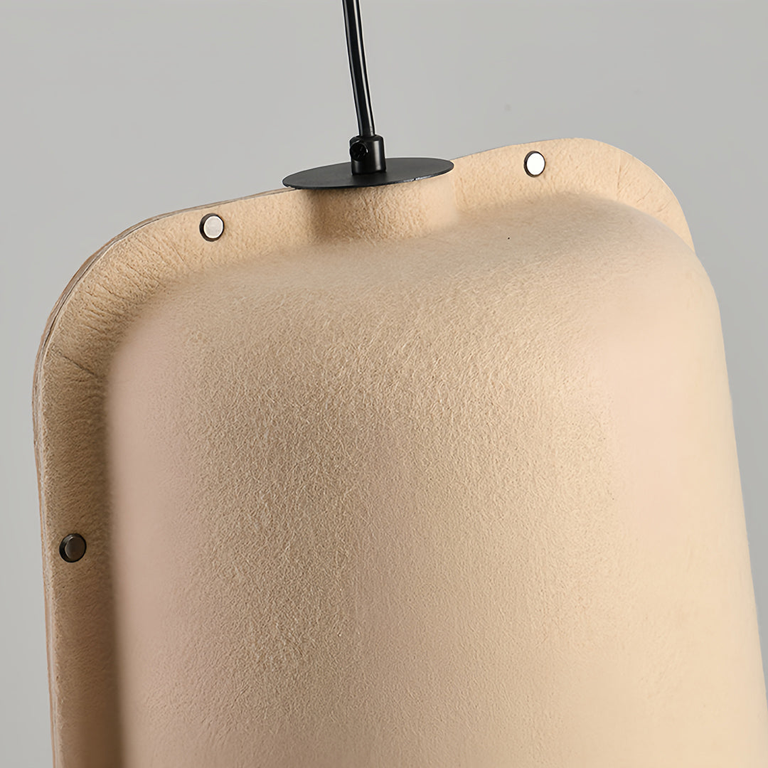 Detailed close-up of a beige felt adjustable pendant light shade showing the texture and connection point to the hanging wire.