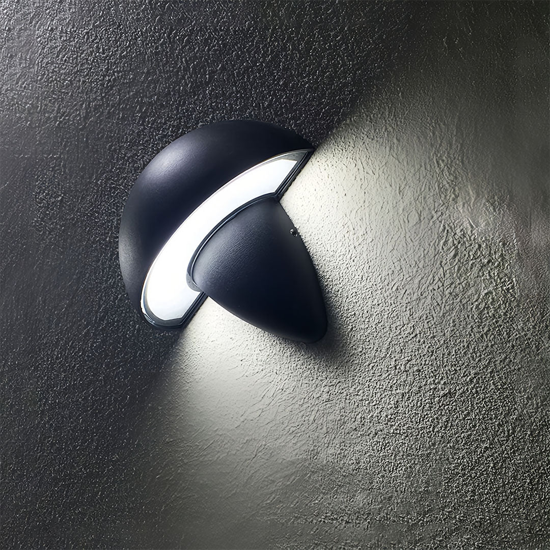 Close-up of a black mushroom wall light installed outdoors, highlighting the clean lines and modern appeal.