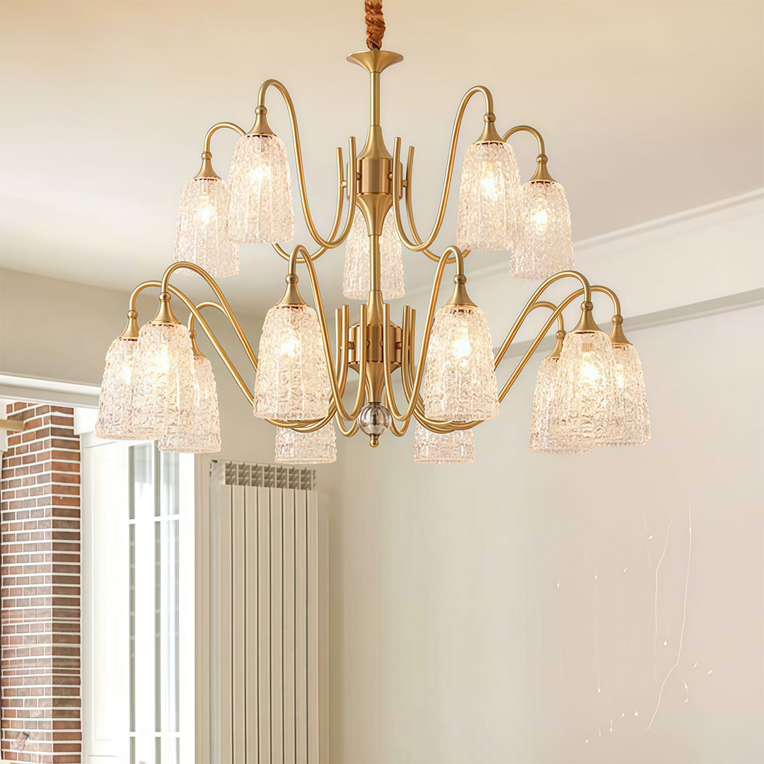 Close-up of a brass vintage chandelier, highlighting the crystal droplets and ornate brass frame.