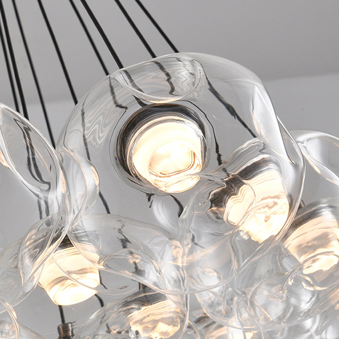 Close-up detail of multi light chandelier showing individual glass bulb connections with warm LED illumination