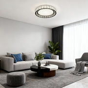 Close-up of a chrome flush mount light, highlighting the crystal details and metallic frame.