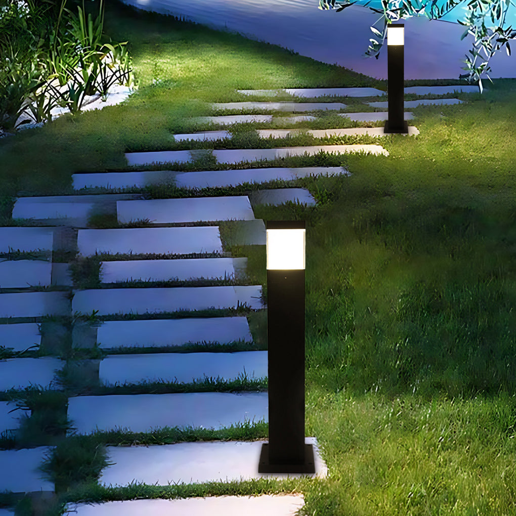 Close-up of commercial bollard lights showcasing sleek black housing and bright LED light diffusion.
