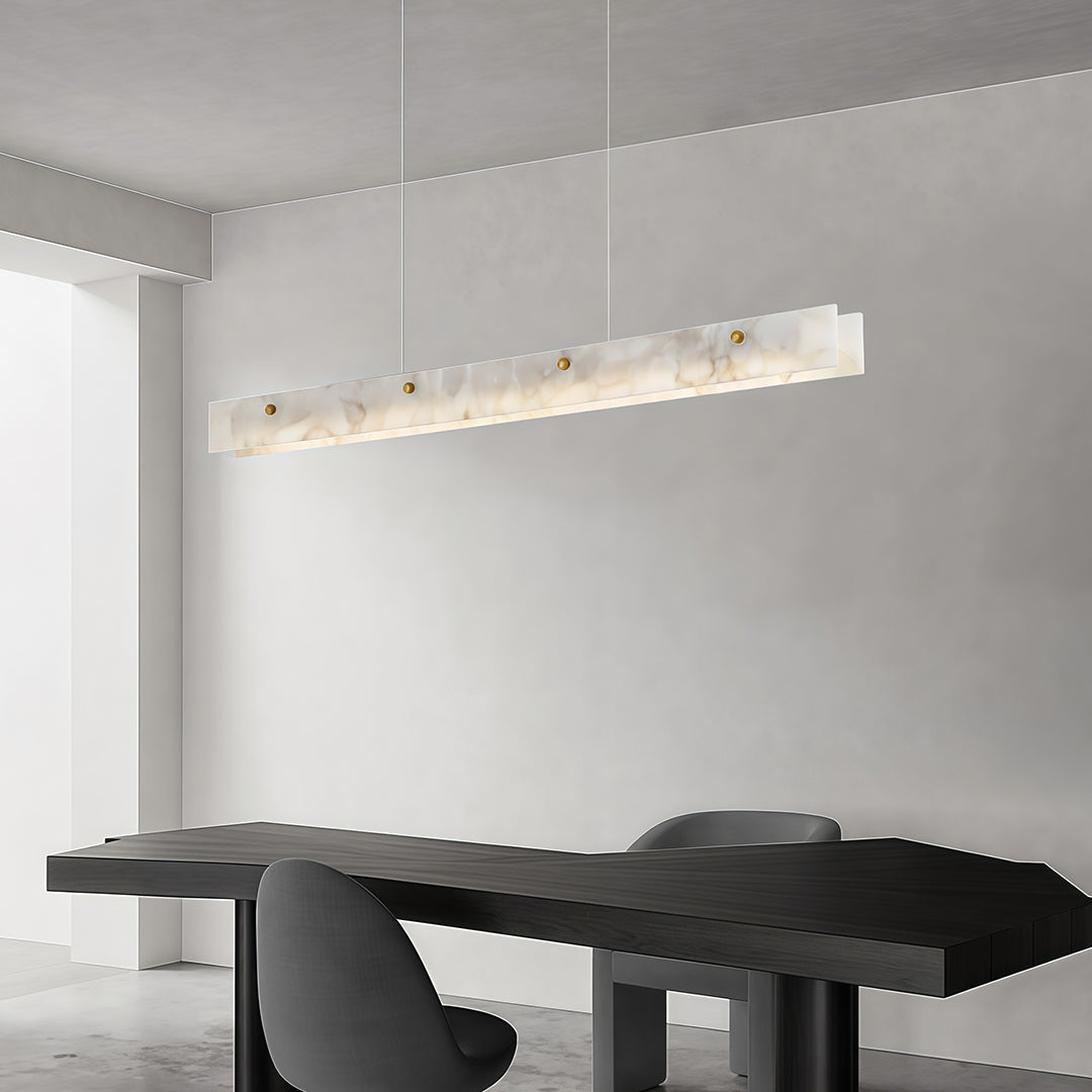 Close-up of a copper metal pendant light, showcasing its unique marble and gold design