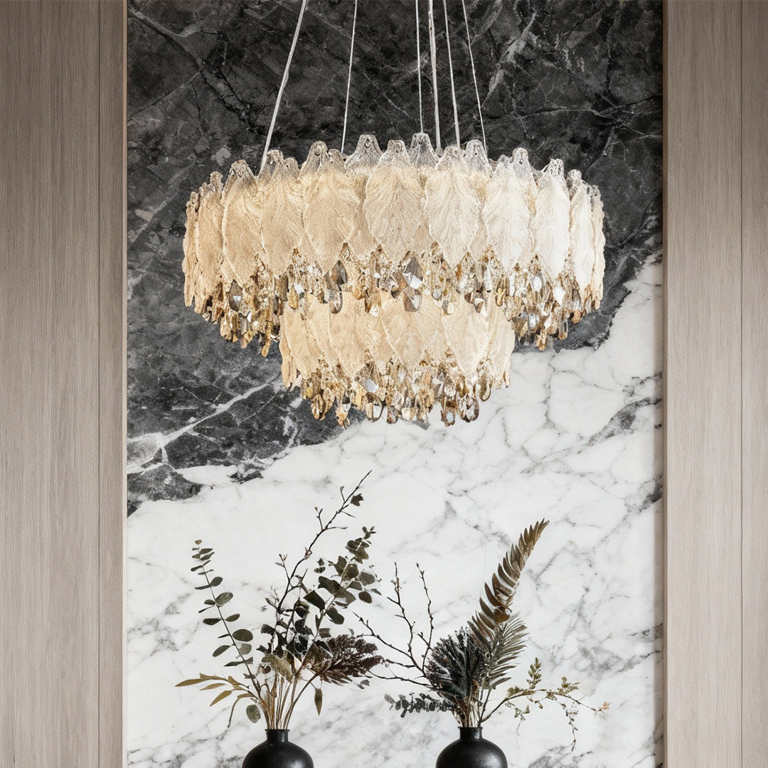 Close-up of French country chandelier showing leaf-shaped crystals and gold accents.