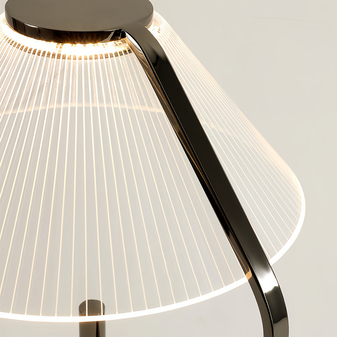 Close-up of a craft floor lamp with a white fabric shade and detailed metal arm
