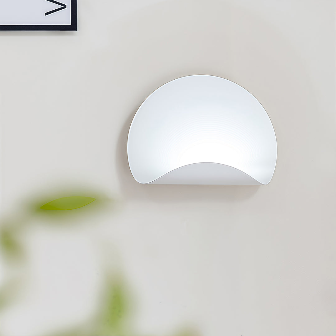 Close-up of the curved white wall lights shade, showing the smooth, clean finish and subtle upward illumination.