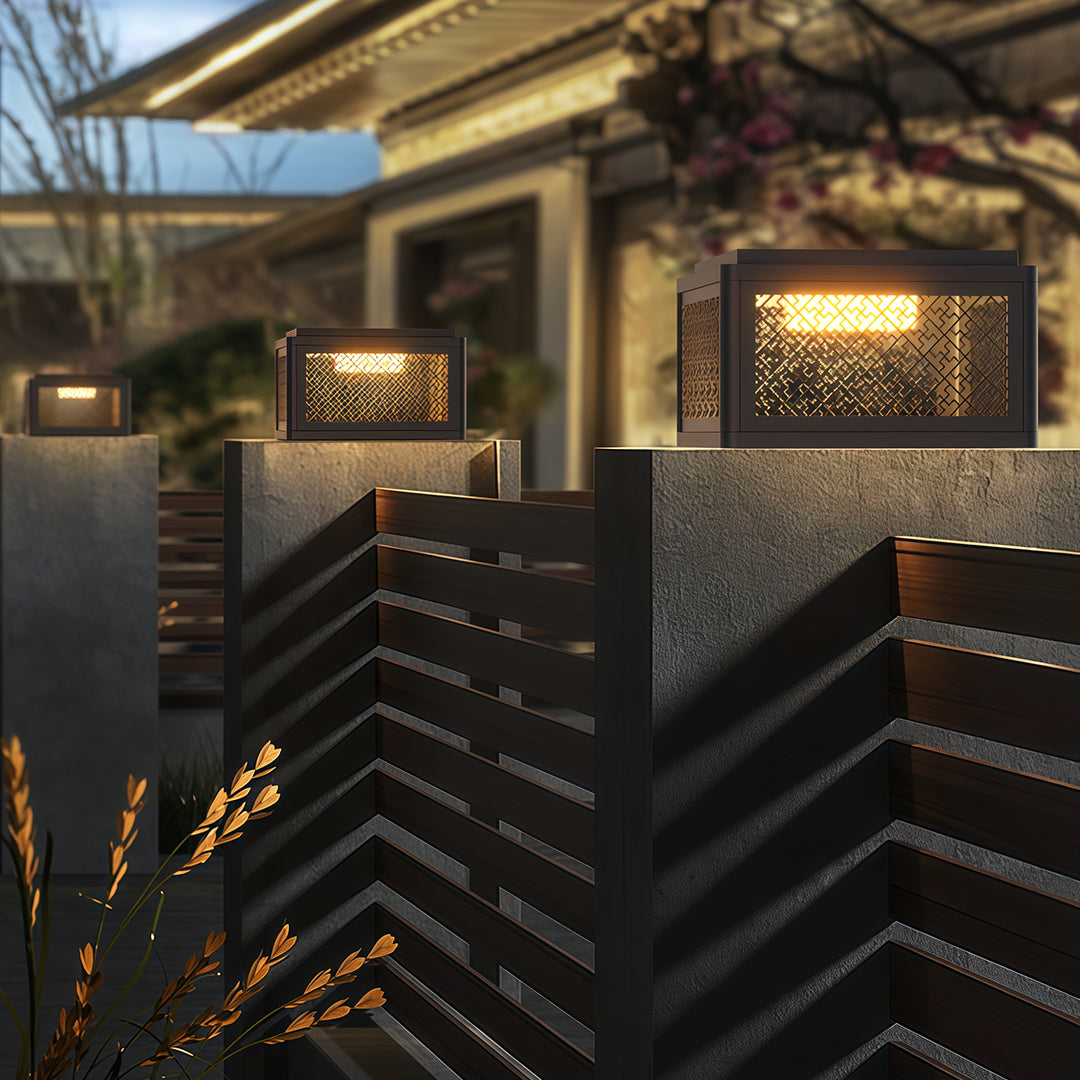 Close-up of a decorative pillar light, highlighting the intricate lattice design and warm light diffusion.