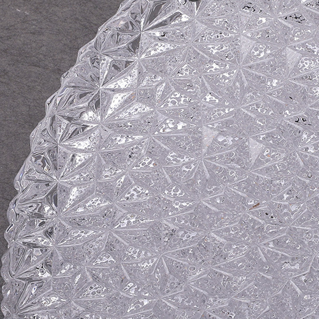 Close up detail of the flush mount crystal ceiling light showing clear faceted geometric glass.