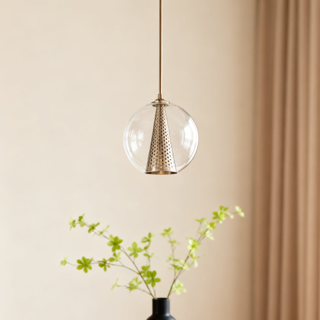 Close-up of the glass ball pendant lights, highlighting the detailed metal grille inside the transparent glass sphere and warm illumination.