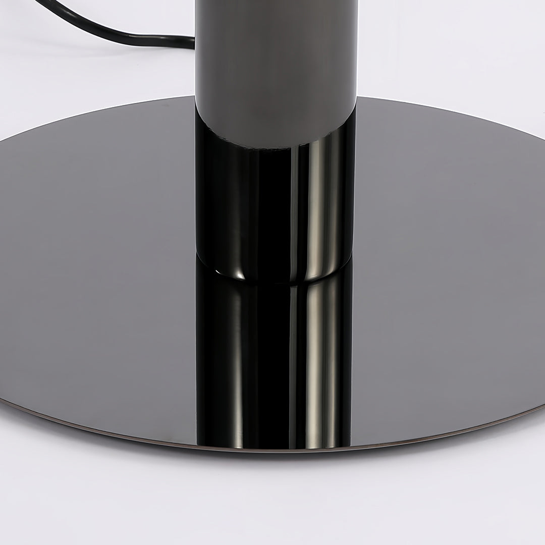 Close-up of a floor lamp base showcasing a sleek black metal finish
