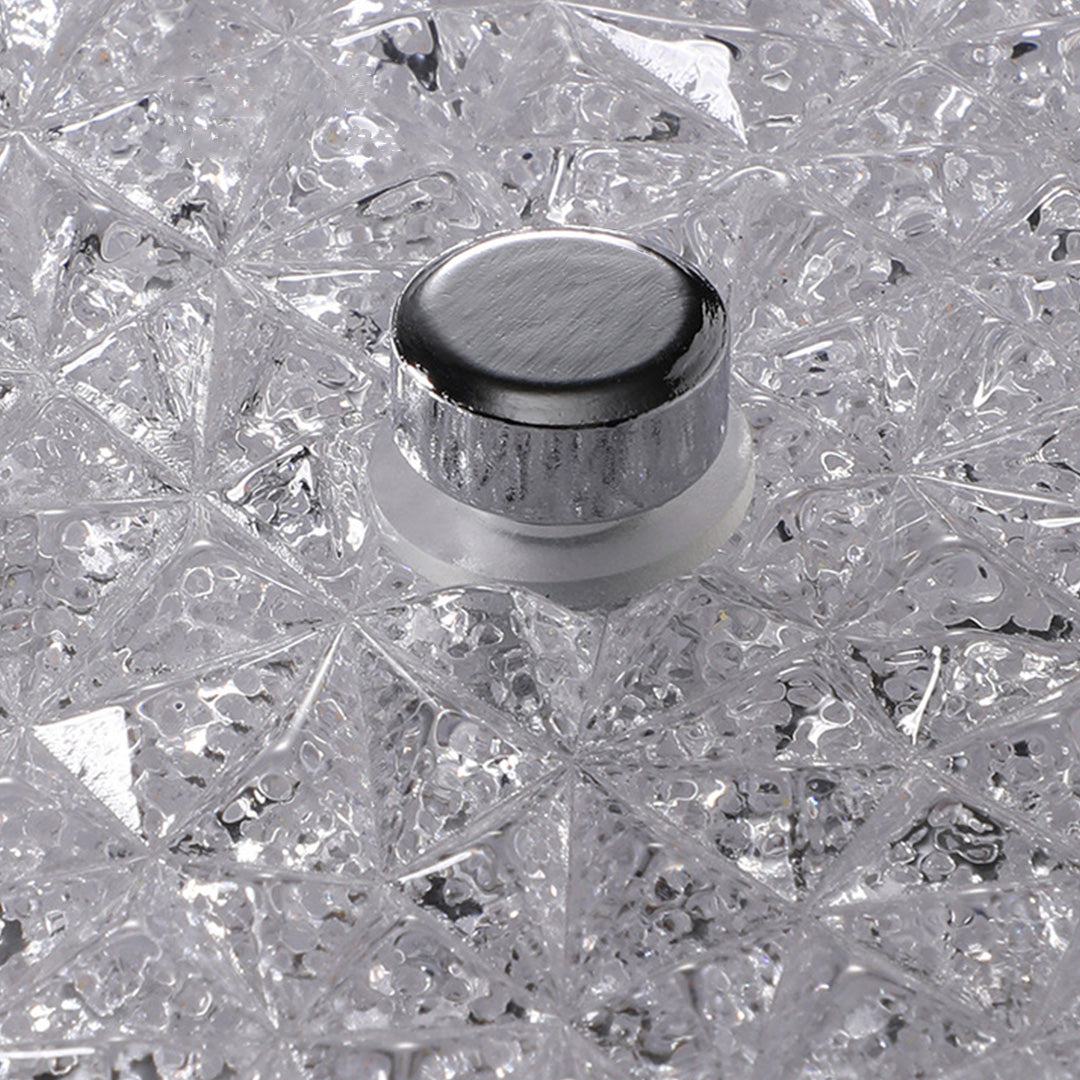 Close-up of the flush mount crystal ceiling light showing its silver center finial and details.