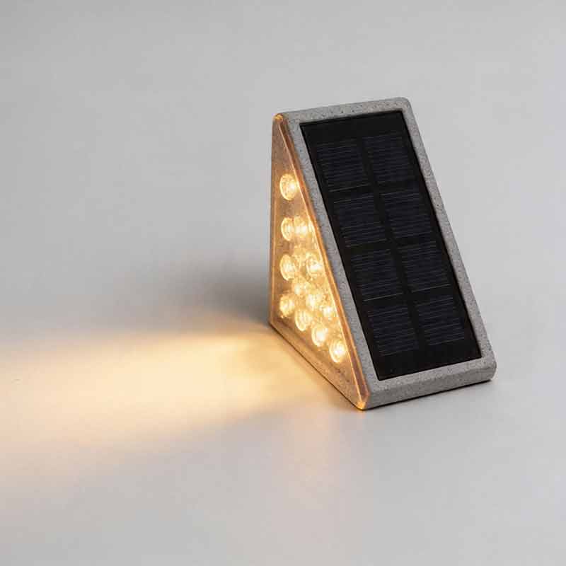 Close up front view showing the textured solar panel of rectangular solar powered lights for steps