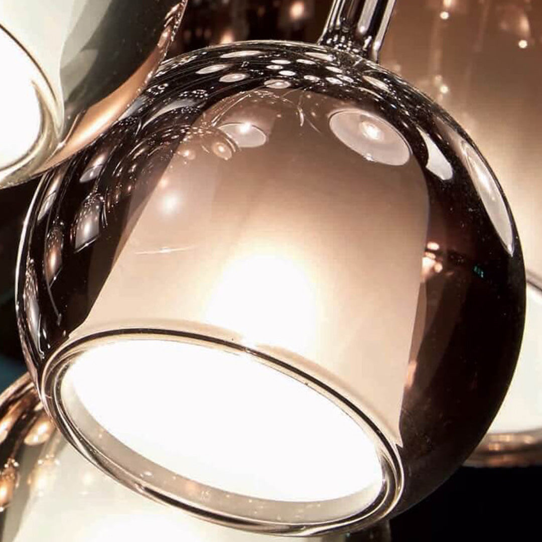 Close-up view of a glass ball pendant light, highlighting its transparent and reflective glass surface.