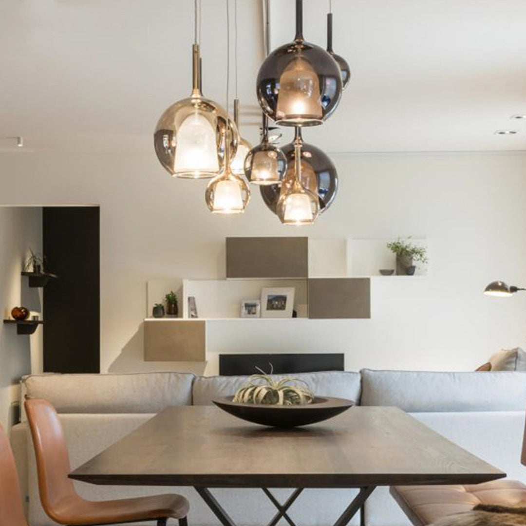 Close-up of glass ball pendant lights hanging in a cluster, showcasing their unique and modern design.