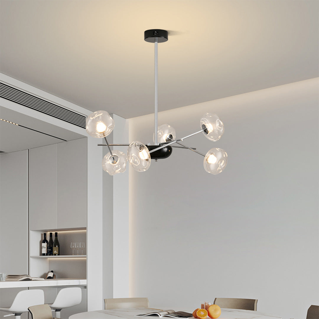 Close-up detail of LED chandelier lights showing transparent glass globe with warm LED bulb illumination