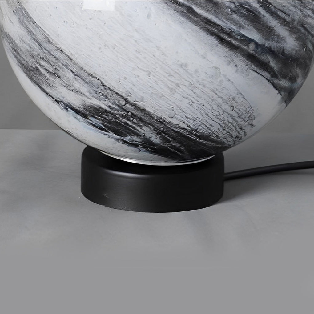 Close-up of globe pillar lights showing detailed marble texture.