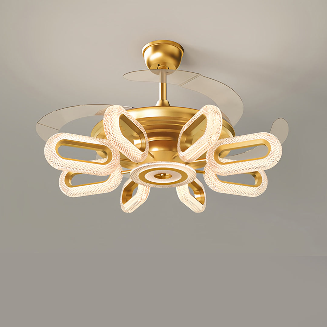 Close-up of gold ceiling fans with lights, showcasing intricate and artistic blade details
