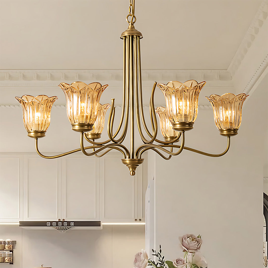 Gold glass chandelier in neutral living space creating ambient lighting with classic brass fixture