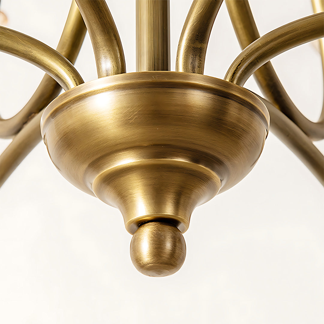 Gold glass chandelier center detail revealing polished brass hub and fixture mounting construction