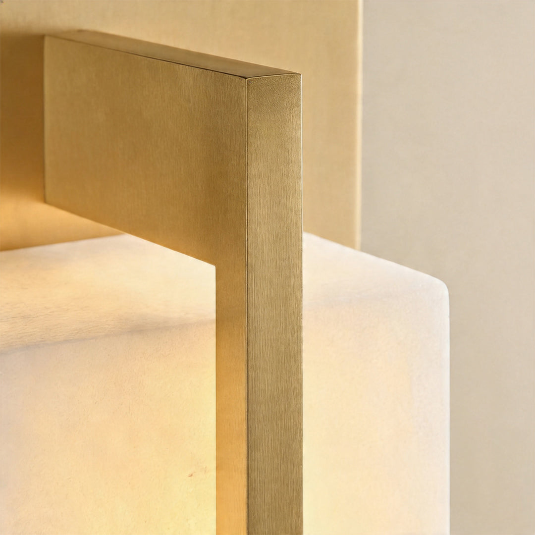 Close up of the sturdy gold wall lighting bracket holding a glowing marble stone shade area ok