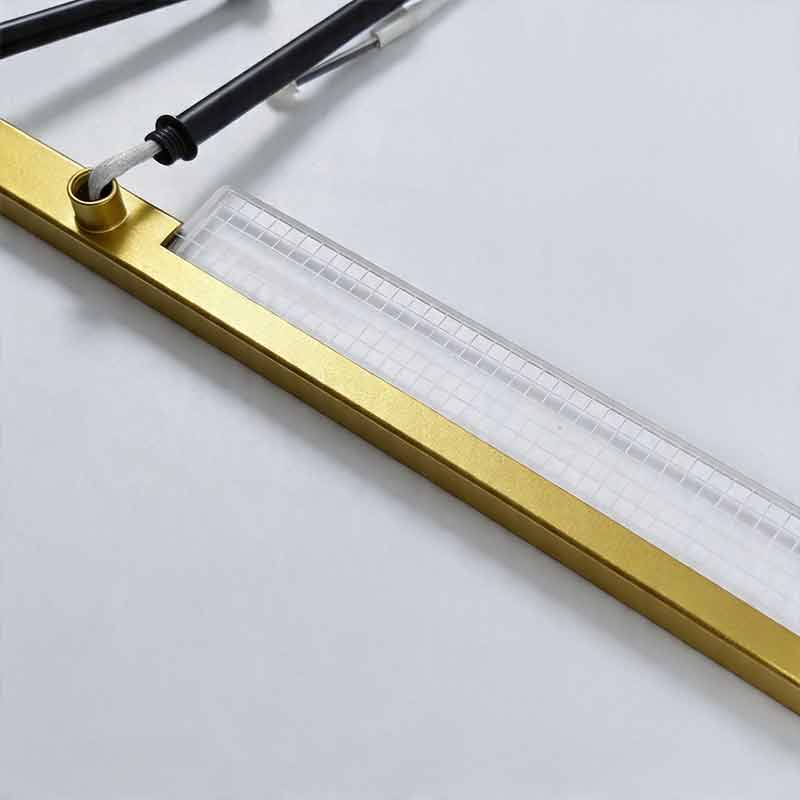 Close up showing the grid patterned acrylic and gold metal frame of a Gold cross ceiling light.