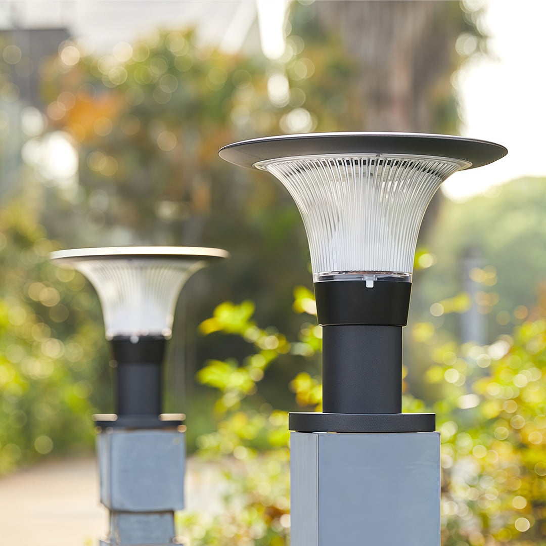 Extreme close-up of the round, 'halo-style' solar panel on top of the fence post cap lights.