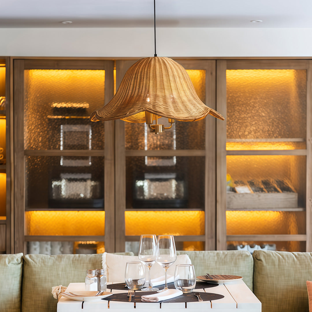 Close-up of a hanging rattan pendant light fixture, showcasing the intricate weaving and warm light.