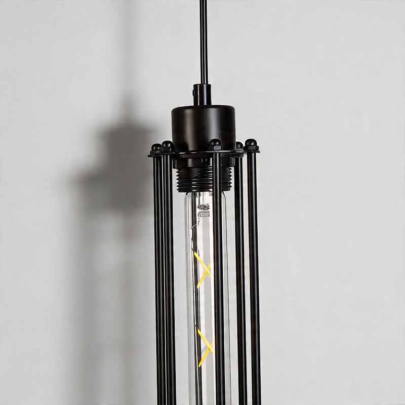 Close up detail of industrial style pendant light fixtures showing the black metal wire cages.