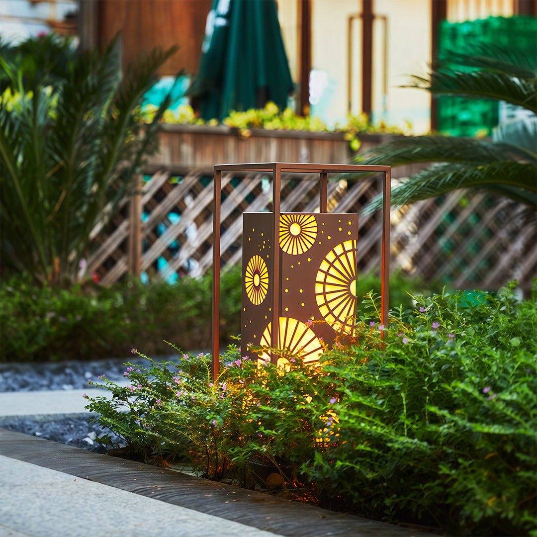 Close-up view of a LED bollard light with decorative metalwork, perfect for brightening outdoor garden features.