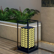 Close-up of LED bollard light with intricate leaf details, providing ambient light in outdoor spaces.