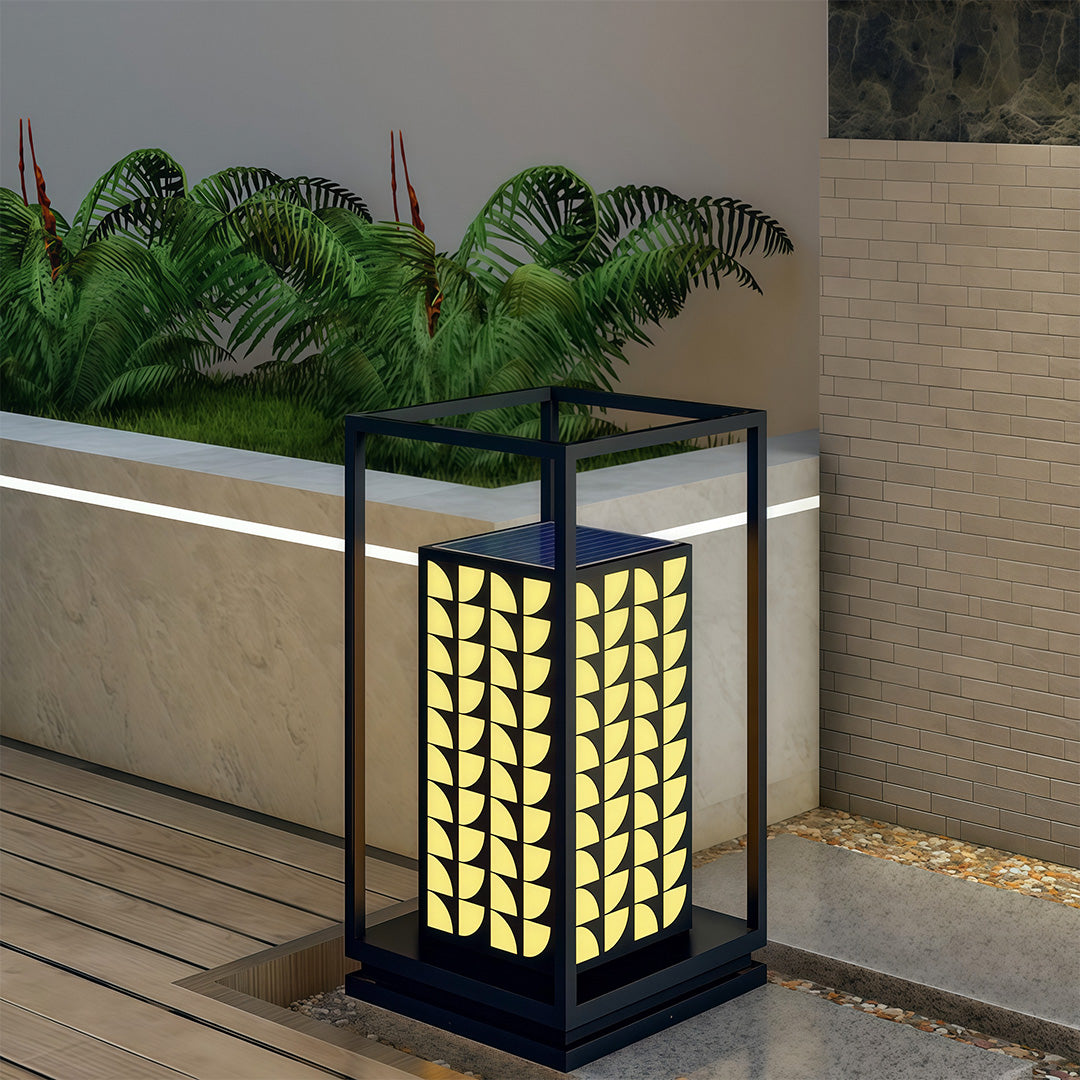 Close-up of LED bollard light with intricate leaf details, providing ambient light in outdoor spaces.