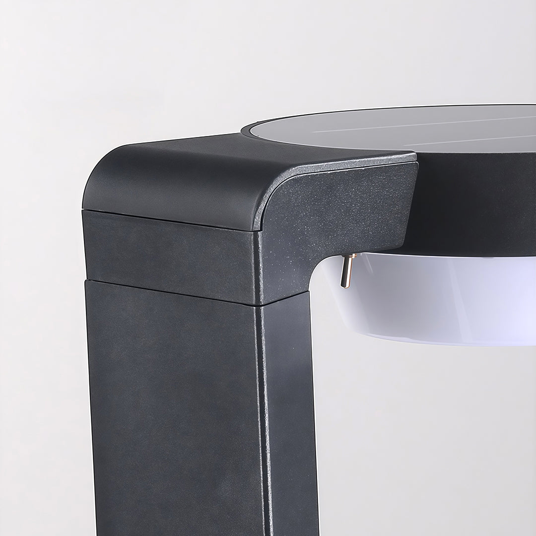 Close-up of LED path light base, showcasing its solar panel and modern design for outdoor lighting.