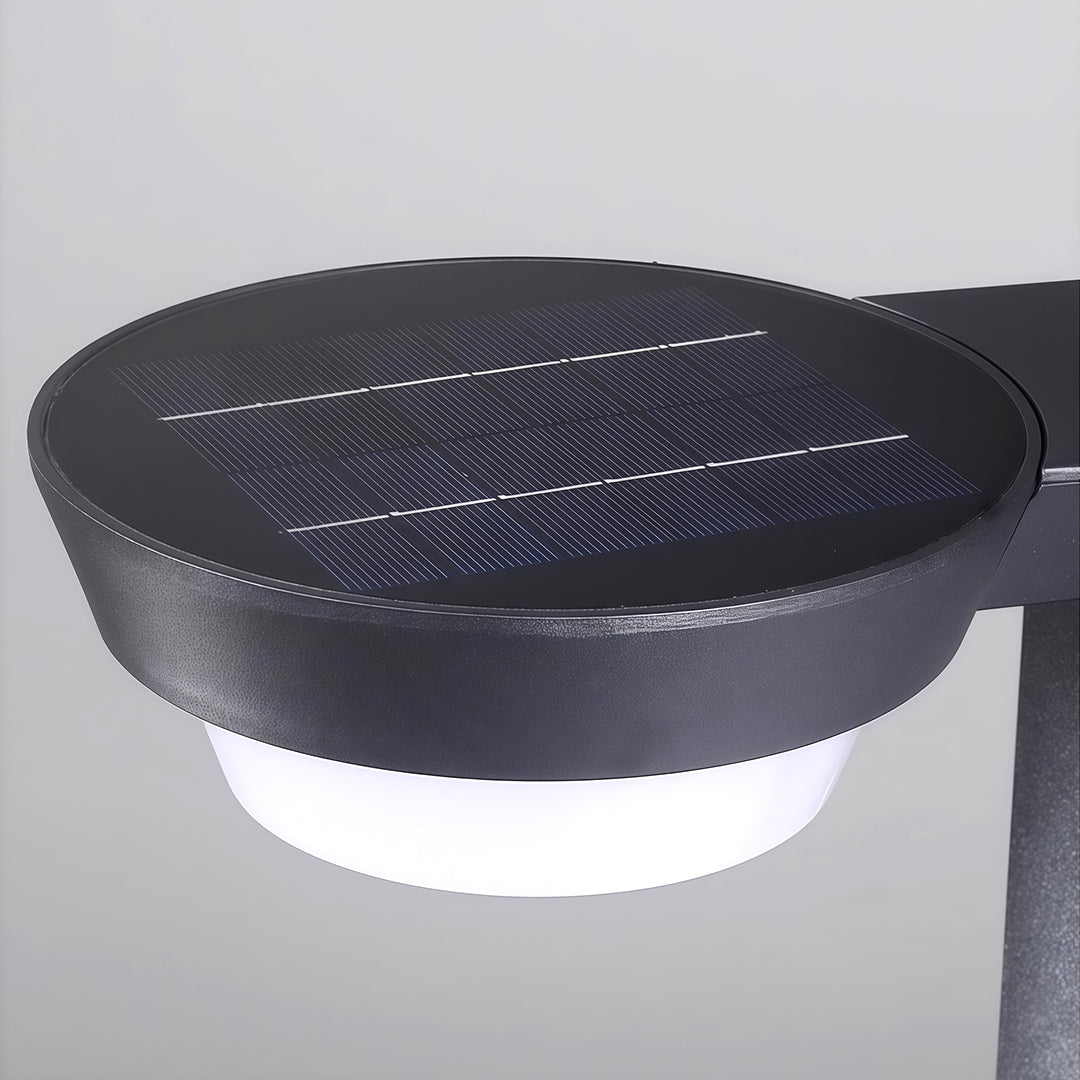 Close-up of LED path light base, showcasing its solar panel and modern design for outdoor lighting.