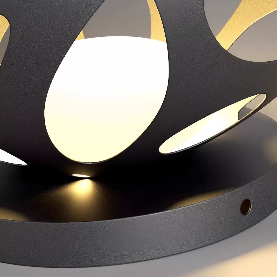 Close-up view of a lighted outdoor planter base showing the warm glow and power button.