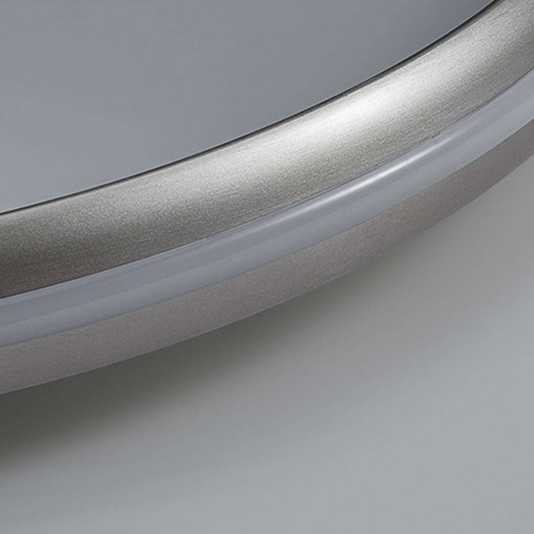 Close-up of metal flush mount light edge, detailed view of brushed metal finish