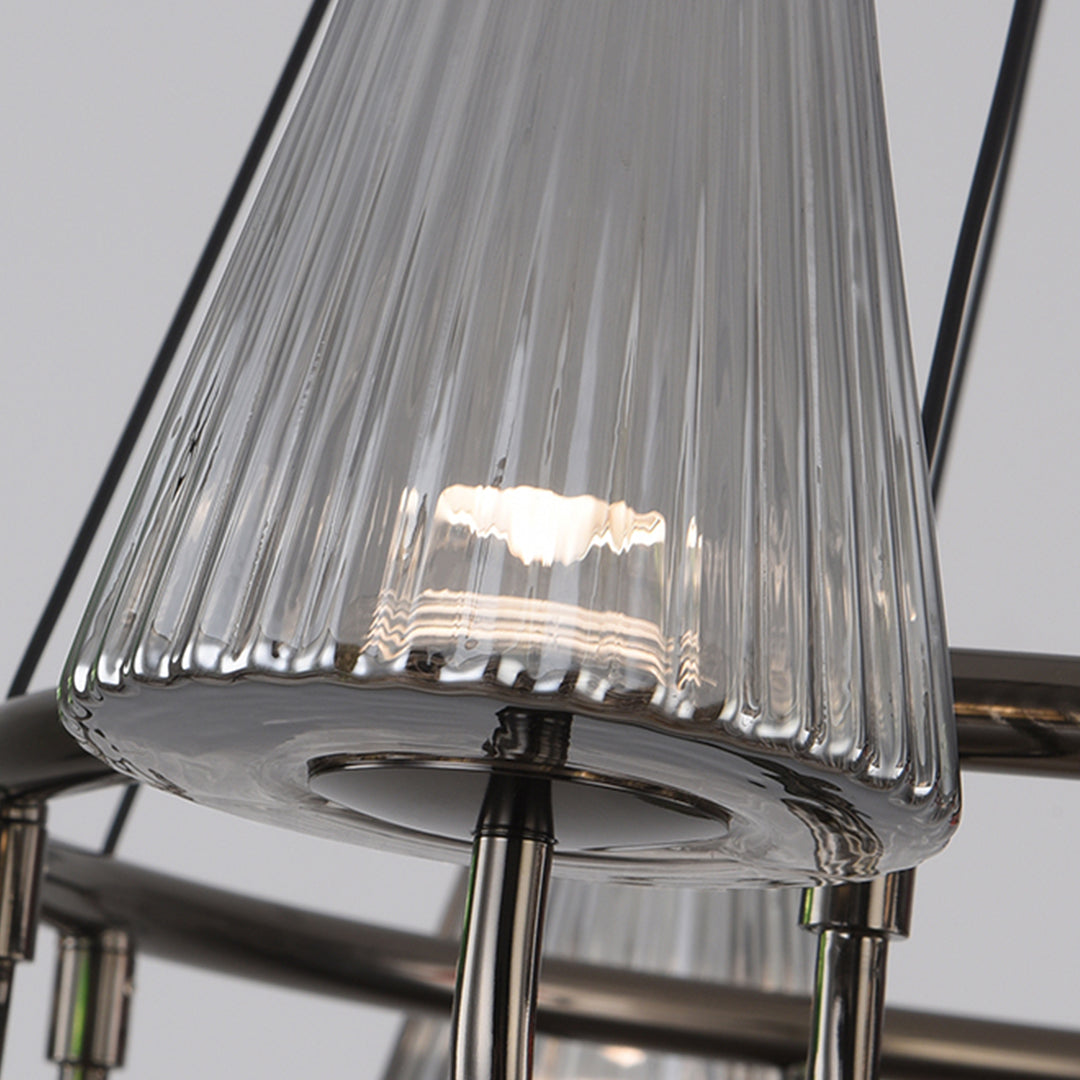 Close-up detail of chandelier arm connection showing decorative metalwork and glass shade mounting