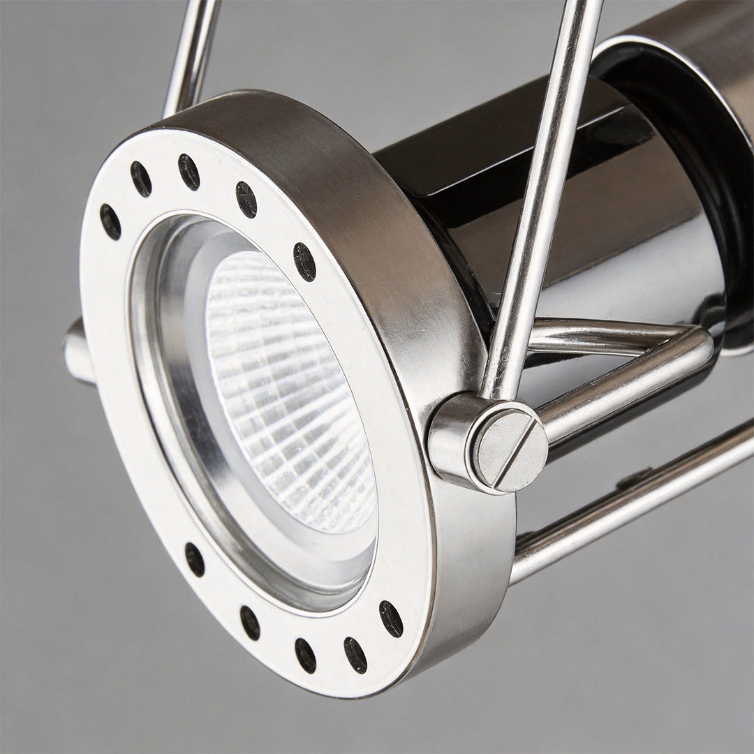 Close-up view of the metallic projector head for industrial wall lights with perforated bezel.