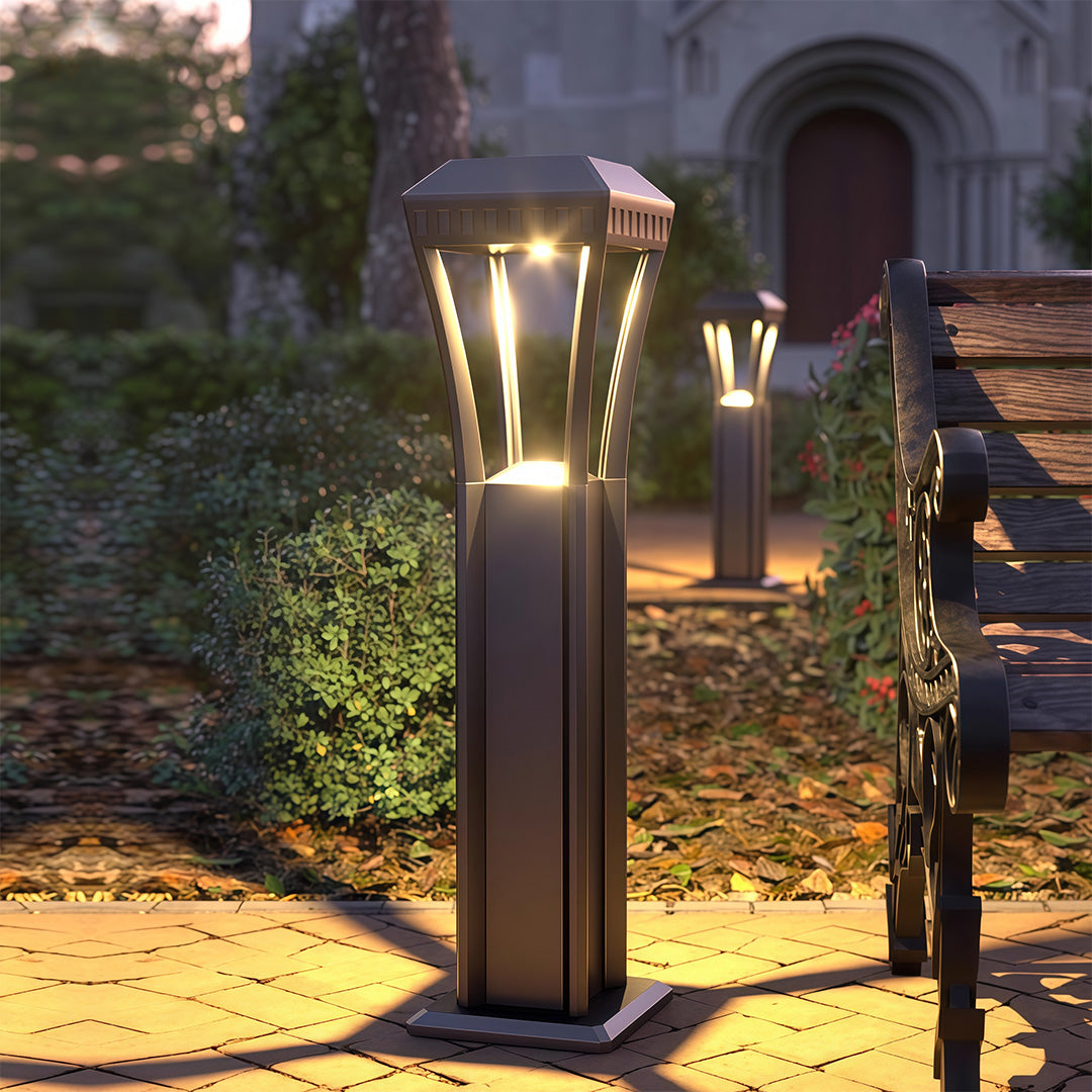 Close-up of a modern bollard light, highlighting the black finish and clear light panel.