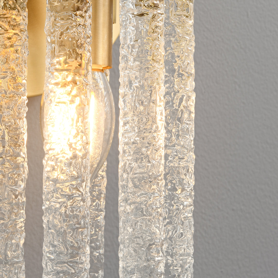 Close up of a modern crystal wall light with glowing bulbs shining through iced glass rods ok
