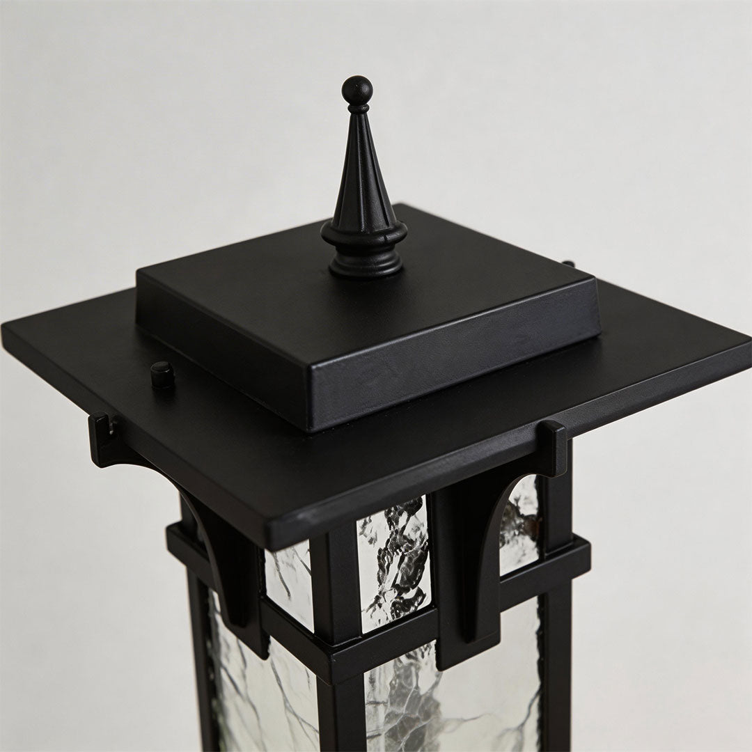 Close-up of a modern path light showcasing its black metal frame and detailed top design.