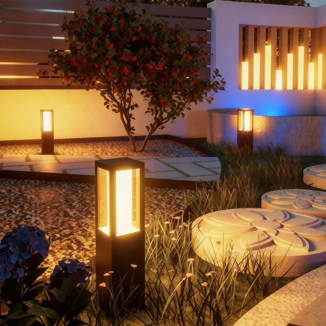 Close-up of an outdoor bollard light, highlighting the black finish and warm light source.