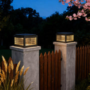 Close-up of an outdoor LED pillar light, highlighting the grid design and warm light diffusion.