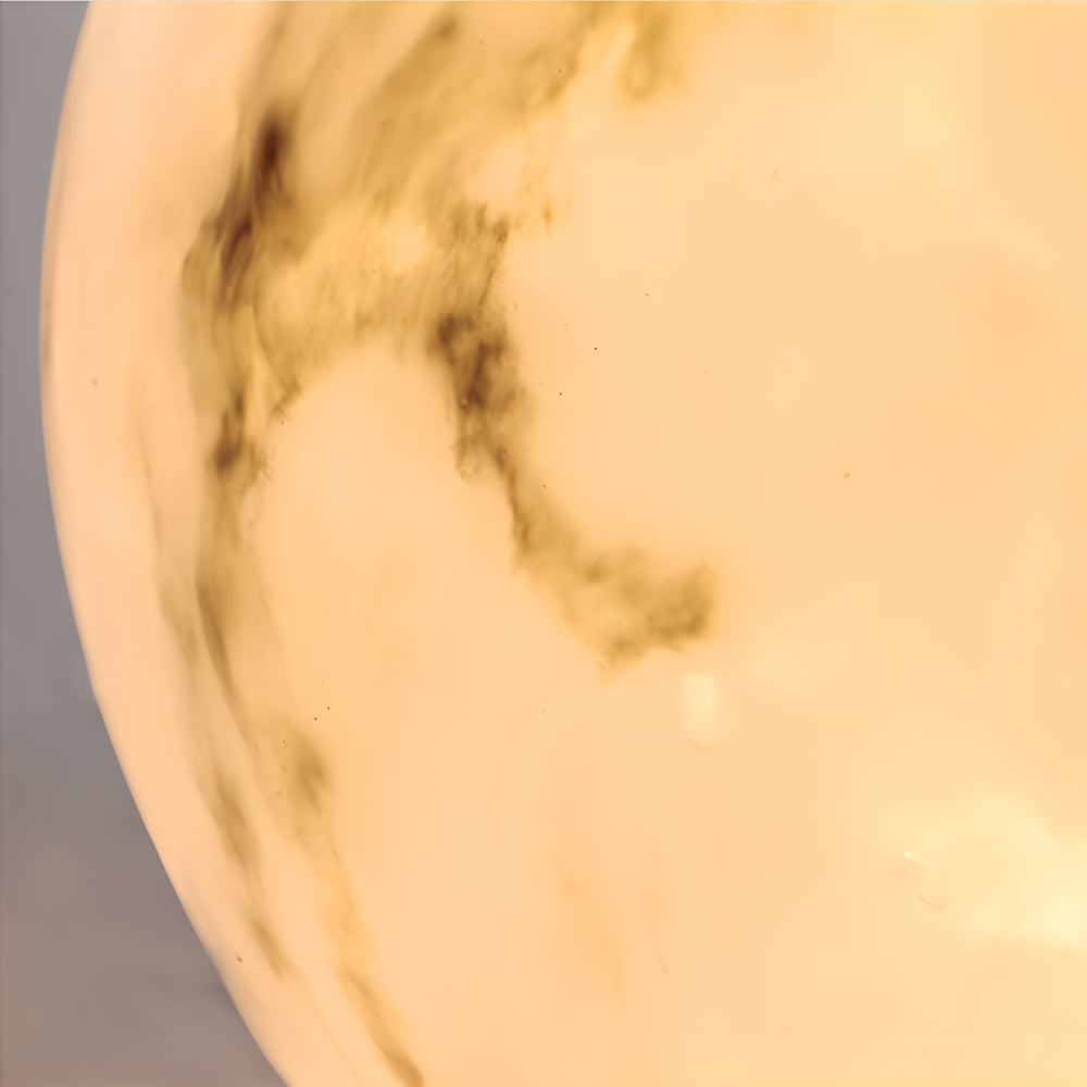 Close up of an outdoor pillar lights, showcasing its marble texture and soft, inviting light.