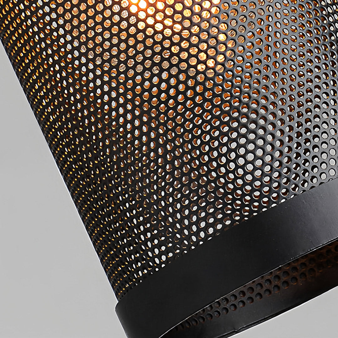 Close-up detail of the fine black perforated metal mesh shade on the retro industrial pendant lights.