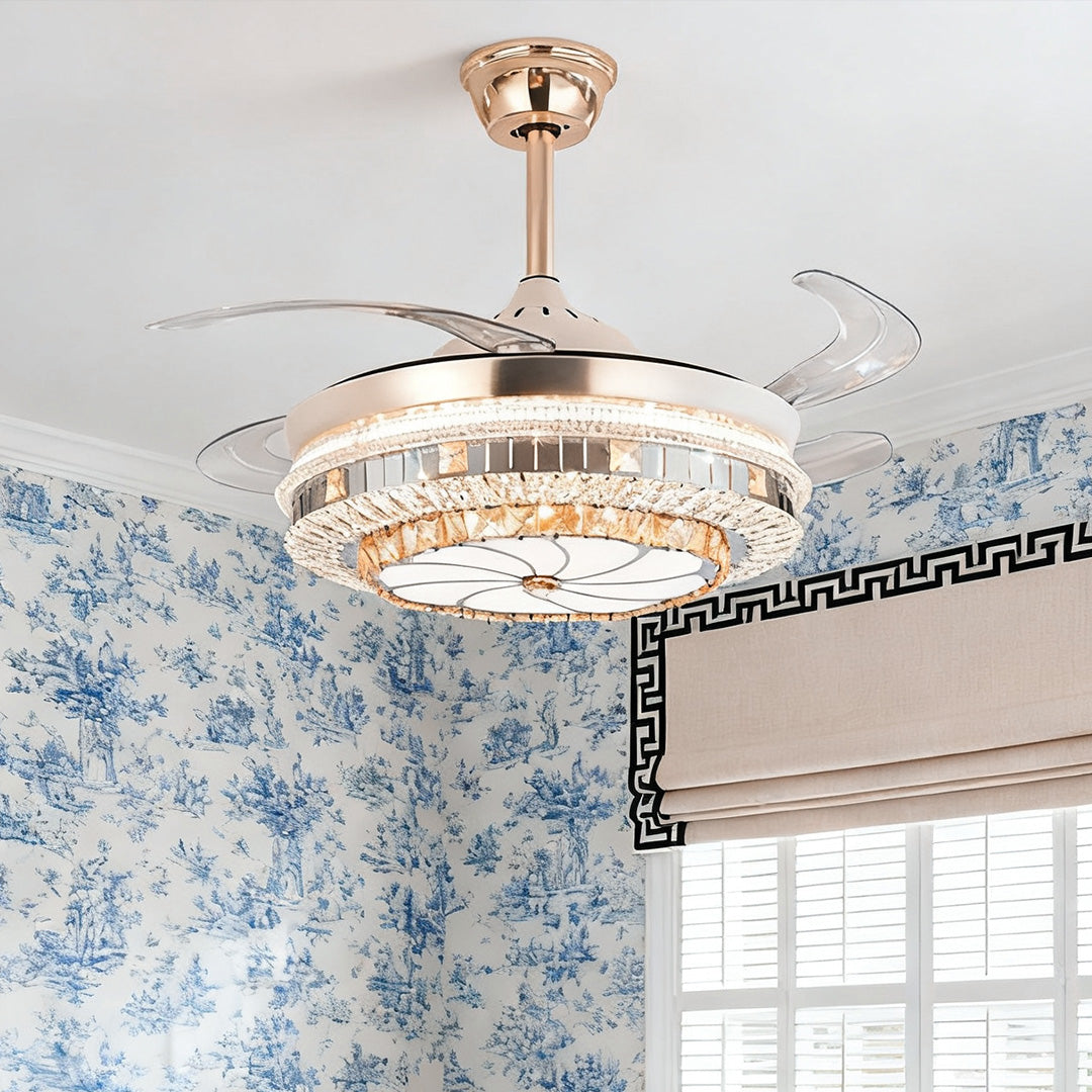 Close-up of the polished gold ceiling fan with light against patterned curtains 