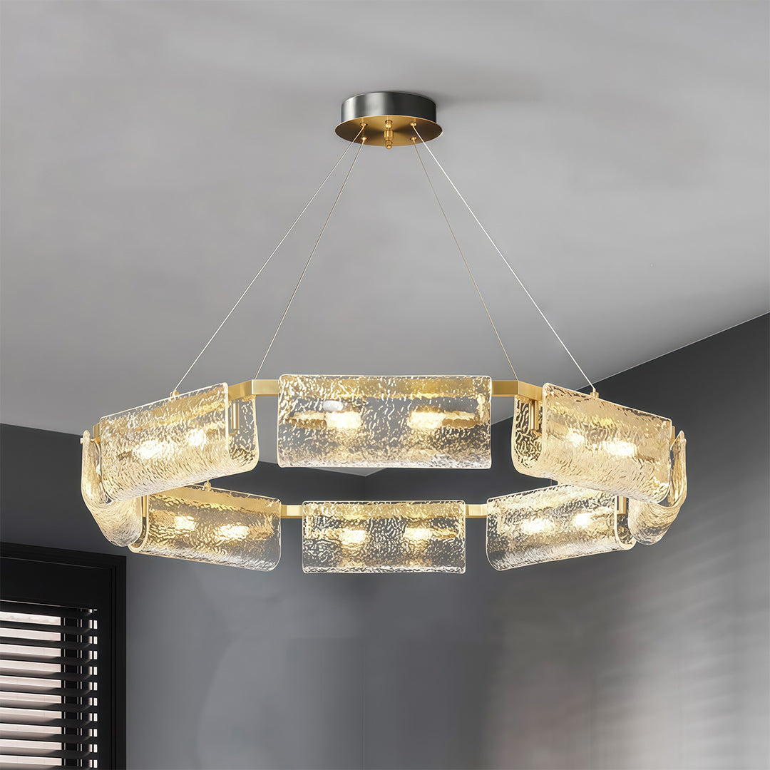 Close-up of a rectangular glass chandelier, highlighting the textured glass and gold frame.